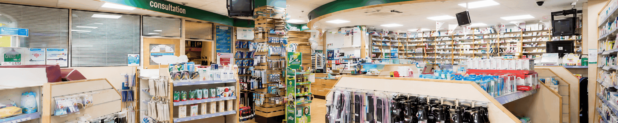 Interior of a pharmacy with shelves of medicines and health products at Travel Clinic Bedford
